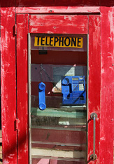 A dilapidated Telstra public phone booth awaits an upgrade in the remote outback town of Oodnadatta on the edge of the Simpson desert