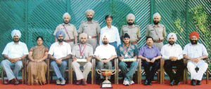 Mr Rajdeep Singh Gill, ADGP-cum-Director, Maharaja Ranjit Singh Police Training Academy, with the two sportspersons honoured for their achievements with senior officers of the academy on Wednesday