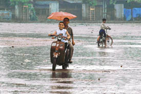 Two kids enjoy a ride in rain at Daresi Ground on Wednesday afternoon in Ludhiana.