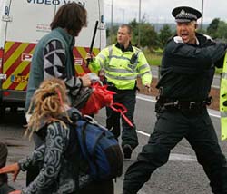 Police moves protesters from the motorway near Gleneagles in Scotland before the start of the G8 summit on Wednesday.