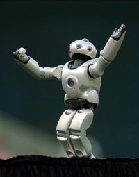 QRIO, the Sony dream robot prototype, with a miniature baseball in hand waves to the crowd before he threw the ceremonial first pitch during the Washington Nationals New York Mets game at RFK Stadium in Washington on Wednesday.