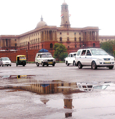 A view of North Block shimmers in the accumulated rainwater on Rajpath on Thursday.