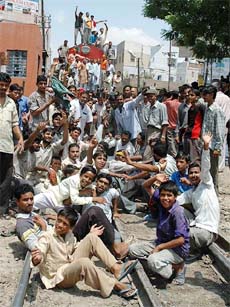 BJP and Bajrang Dal activists squat on the railway track in Bikaner during the Rajasthan bandh