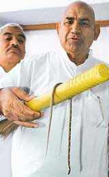 Mr Ram Kumar Gautam, MLA from Haryana, shows a snake that had entered his third-floor flat in Sector 3, Chandigarh, on Friday.