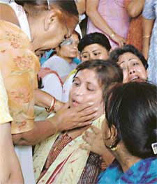 Dixits mother being consoled by relatives
