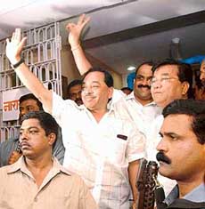 Expelled Shiv Sena leader Naryana Rane with his MLAs greets his supporters outside his official residence in Mumbai on Friday.