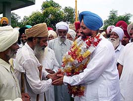 Mr Pratap Singh Bajwa, PWD Minister, Punjab, meets the SAD workers who joined the Congress at Balagam village on Friday.