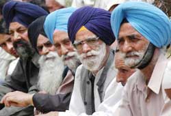 Sikh supporters listen to Jammu and Kashmir Chief Minister Mufti Mohammad Sayeed during his visit to shrine at Kreeri in Baramula on Saturday.