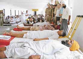 Inmates of Central Jail being administered acupuncture therapy on the jail premises in Ludhiana on Friday