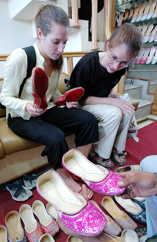 Foreign tourists Gudrun Trok and Nina Diebalek shop for traditional Punjabi juttis in Amritsar on Sunday.