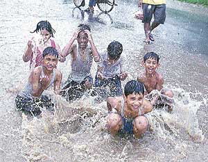 Children make the most of Sunday afternoons sudden showers in Chandigarh.