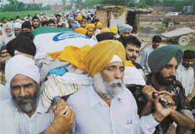 Ex-serviceman Jaswant Singh acts as a pall-bearer to his son Harjinder Singh of 13 Sikh Regiment who attained martyrdom in the Kashmir Valley
