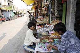 Children play games at a shop on a deserted street close to the Hanuman Garhi temple in Ayodhya