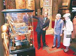 Japans Emperor Akihito and Empress Michiko look at a throne of King Tutankhamun as they visit the Egypt pavilion at the 2005 World Exposition in Nagakute, central Japan on Monday