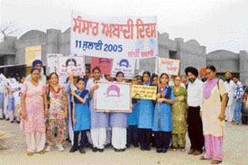 Students of Government Senior Secondary School for Girls with banners and posters on World Population Day at Sahnewal on Monday