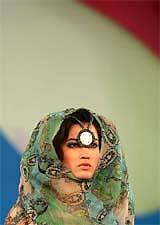 A model presents a creation by Indonesian designer Ika' as part of her "Sahara Crossing" fashion show