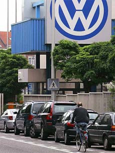 A cyclist rides past the main entrance to German carmaker Volkswagens Brussels plant, Belgium