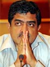 Infosys Chief Executive Officer Nandan Nilekani reacts during a news conference in Bangalore