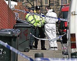 A forensics officer leaves a house in Leeds in northern England after conducting raids in connection with the London bombings, on Tuesday