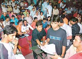 Students wait for their turn at the combined admissions for various engineering courses at Law Auditorium of Panjab University