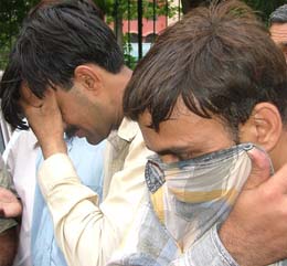 Saleem Rehman and Shaukat Ali after their arrest by the police for trying to sell a kidnapped infant girl in the Capital