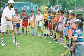 Revival Efforts: Youngsters are given training in the village hockey grounds where infrastructural inadequacies are glaring. 
