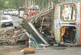 A truck loaded with scrap overturned at Singhpura Bhudda village, blocking the Ambala-Kalka highway near Zirakpur on Friday.