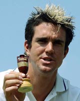 England batsman Kevin Pietersen holds the Ashes urn during a press conference at Lords in London