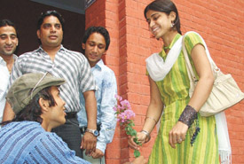 A senior student trying to break the ice with two freshers as they enter the college for the first day in the Capital on Saturday.
