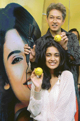 Indian hair stylist Jawed Habib (standing) and model Sarah Jane (seated) pose for photographers at the launch of Sunsilk Velvety Soft shampoo in New Delhi on Sunday.