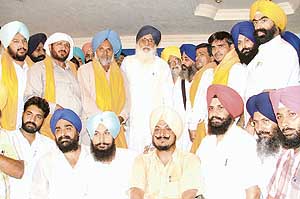 Members of the Bahujan Samaj Party with the SAD-B chief, Mr Parkash Singh Badal, after joining the party in Ludhiana on Sunday.