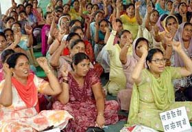 Members of the Anganwadi Mulazim Union hold a protest rally in support of their demands at Desh Bhagat Yaadgar Hall in Jalandhar