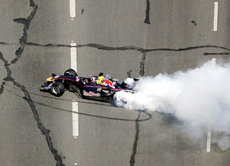Red Bull racing team driver David Coulthard spins his car on the Bosphorus bridge connecting Istanbuls European and Asian sides on Sunday.