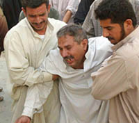 A man breaks down as he grieves for relatives killed in a suicide bomb attack in Musayyib town 60 km South of Baghdad on Sunday. Stricken townspeople swept away the wreckage of a fuel truck bomb that killed 70 people south of Baghdad as three more suicide car bombers struck the Iraqi capital on Sunday in a relentless new campaign.