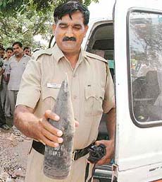 A policeman holds a shell found in Mani Majra, Chandigarh