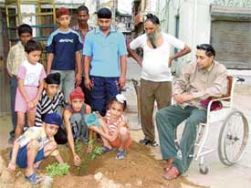 Varinder Kumar Singh, a nine-year-old boy plants a sapling on the occasion of his birthday