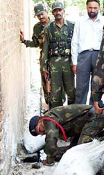 Army experts puts bags around the live grenades recovered from a drain at Pathankot railway station on Monday.