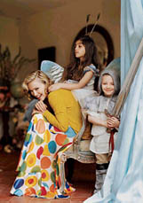This photo supplied by Vogue shows Madonna playing dressup with her children Lourdes (7) and Rocco (4) at the English country estate she shares with her husband, Guy Ritchie, and two children. 