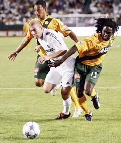 Real Madrids Zinedine Zidane passes Los Angeles Galaxys Ugo Ihemelu (right) and Tyrone Marshall during an exhibition soccer match at the Home Depot Centre in Carson, California, on Monday