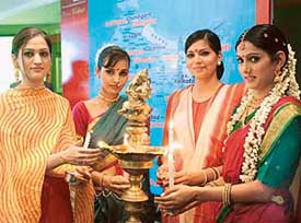 Girls light a lamp to mark the start of Project Vistaar, a plan announced by Microsoft to reach out to over 26 cities across India, during a press conference in New Delhi on Wednesday.