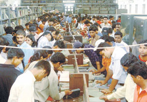 College students throng Delhi Universitys Central Library to pick up old books being sold for a token price of Re 1 each. 