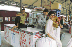 Vendors pass their time sitting at a closed tea stall at the Ludhiana railway station.