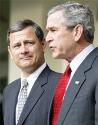 US President George W Bush speaks to reporters as he and Supreme Court nominee John Roberts make their way to the Oval Office after having breakfast together at the White House