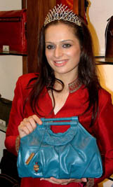 Miss India-Universe 2005 Amrita Thapar poses with a bag from the new Riviera collection from Hidesigns in New Delhi on Thursday. 