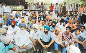 ETTU members and parents of arrested teachers sit on a dharna at the court complex on Friday