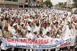 Activists of Pakistans Opposition Islamic Alliance (MMA) chant slogans against the governments crackdown on madarsas in Karachi on Friday.
