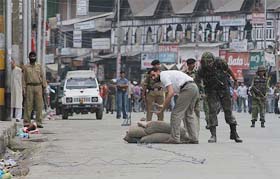A hand grenade covered with sandbags lies in a street of Srinagar