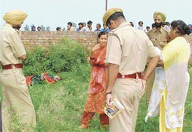 Police personnel on the plot where the body of a Nepalese woman was found in Ludhiana on Saturday