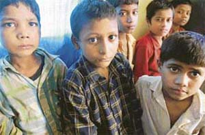 Child labourers rescued from different factory units wait inside a police station in Mumbai