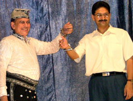 Magician Samrat Shankar handcuffs SSP Kapil Dev during a show in Bathinda on Friday.